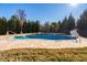 Inviting backyard pool with tile surround, set in a spacious yard with mature trees at 78 Rolling Meadows Ln, Chapel Hill, NC 27517