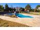 Kidney shaped pool and spa surrounded by a spacious patio, and backyard playset at 78 Rolling Meadows Ln, Chapel Hill, NC 27517