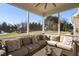 Screened porch with a cushioned sectional, wicker table and a view of the backyard at 78 Rolling Meadows Ln, Chapel Hill, NC 27517