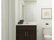 Bathroom features a dark wood vanity, white countertop, modern fixtures, and a toilet at 830 Basswood Gln Trl, Knightdale, NC 27545
