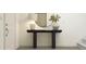 Classic entryway with a dark wood console table, mirror, lamp, and decor on display at 830 Basswood Gln Trl, Knightdale, NC 27545