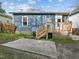 Back of home features a small deck and concrete patio overlooking a large, level backyard at 908 Spruce St, Durham, NC 27701