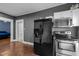 Kitchen with black appliances, stainless steel microwave, and updated features at 908 Spruce St, Durham, NC 27701