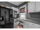 Kitchen with white cabinets, stainless steel appliances, and a cozy window view at 908 Spruce St, Durham, NC 27701