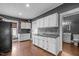 Traditional kitchen with white cabinetry, and a stainless steel sink, perfect for a starter home at 908 Spruce St, Durham, NC 27701