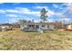 Spacious backyard with a well-maintained lawn, deck, and mature trees at 9817 Holly Springs Rd, Holly Springs, NC 27540