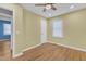 Bedroom with hardwood floors, ceiling fan, and natural light at 9817 Holly Springs Rd, Holly Springs, NC 27540