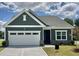 Charming home featuring a well-manicured lawn, a two-car garage, and tasteful exterior color scheme at 100 Big Dream Ct, Louisburg, NC 27549