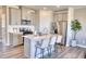Stylish kitchen with stainless steel appliances, white cabinets, and center island with breakfast bar at 1171 Abbott St, Mebane, NC 27302