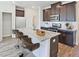Kitchen features dark cabinets, stainless steel appliances, and a large island with granite countertops at 1173 Abbott St, Mebane, NC 27302