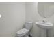 Elegant half-bathroom with modern fixtures, pedestal sink, and neutral decor at 12 Rolling Banks Dr, Louisburg, NC 27549