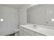 Modern bathroom featuring sleek white cabinets, countertops, and a tub with a shower at 12 Rolling Banks Dr, Louisburg, NC 27549