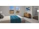 Bright bedroom with two large windows, a wooden dresser, and an ensuite bathroom at 12 Rolling Banks Dr, Louisburg, NC 27549