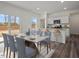Elegant dining area with marble table, seating for eight, and natural light from sliding glass doors at 12 Rolling Banks Dr, Louisburg, NC 27549