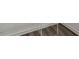 Close-up of new light brown wood-look flooring and white trim at 12 Rolling Banks Dr, Louisburg, NC 27549