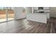 Open floor plan showcasing a kitchen island with stainless sink, and adjacent dining area at 12 Rolling Banks Dr, Louisburg, NC 27549