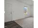 Well-lit room featuring modern flooring, a front door, and a large window for natural light at 12 Rolling Banks Dr, Louisburg, NC 27549