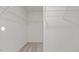 Spacious walk-in closet with white wire shelving and neutral carpet at 12 Rolling Banks Dr, Louisburg, NC 27549