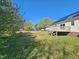 Backyard featuring a wooden deck, lawn and large trees at 120 Keith Ct, Willow Springs, NC 27592