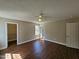 Bedroom with wood-look floors, ceiling fan, closet, and view of the back yard at 120 Keith Ct, Willow Springs, NC 27592