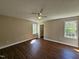 Bright, spacious bedroom featuring wood-look flooring, ceiling fan and ample natural light at 120 Keith Ct, Willow Springs, NC 27592