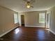 Comfortable bedroom with wood-look flooring, ceiling fan, and well-lit windows at 120 Keith Ct, Willow Springs, NC 27592