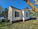 Side view of a home with black shutters and vinyl siding at 120 Keith Ct, Willow Springs, NC 27592