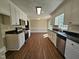 Spacious kitchen with stainless steel appliances, black countertops, and wood-look floors at 120 Keith Ct, Willow Springs, NC 27592