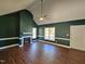 Open living room with a fireplace, ceiling fan, hardwood floors and natural light at 120 Keith Ct, Willow Springs, NC 27592