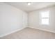 Cozy bedroom with neutral walls, carpet, and a window that allows natural light to flood the room at 123 Weavers Grove Dr, Chapel Hill, NC 27514