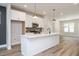 Stylish kitchen featuring white cabinetry, a central island, stainless steel appliances, and wood flooring at 123 Weavers Grove Dr, Chapel Hill, NC 27514