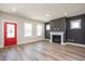 Inviting living room with wood floors, a charming fireplace, a red door, and ample natural light at 123 Weavers Grove Dr, Chapel Hill, NC 27514