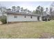 View of home's exterior with light siding, lawn, covered area, and parked vehicles at 1545 N Nc 87, Elon, NC 27244