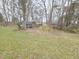 A spacious backyard featuring a blue shed and a mix of open grassy area and some bare patches at 1545 N Nc 87, Elon, NC 27244