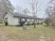 Ranch-style home with light siding, blue shutters, and a covered carport, offering classic charm at 1545 N Nc 87, Elon, NC 27244
