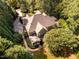 Beautiful aerial view of estate home surrounded by mature trees and lush landscaping at 1616 Kirkby Ln, Raleigh, NC 27614