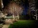 Outdoor entertainment area with stone patio, string lights, and green grass at 1616 Kirkby Ln, Raleigh, NC 27614