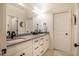 Modern bathroom with a double sink vanity with gray countertops and stylish fixtures at 1616 Kirkby Ln, Raleigh, NC 27614