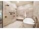 Contemporary bathroom with a soaking tub, dual showerheads, and a neutral color palette for a calming ambiance at 1616 Kirkby Ln, Raleigh, NC 27614