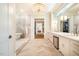 Luxurious bathroom with herringbone tile flooring, soaking tub, glass shower, and large vanity with ample storage at 1616 Kirkby Ln, Raleigh, NC 27614