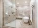 Modern bathroom with dual shower heads, soaking tub, neutral tile, and glass partition for a sleek design at 1616 Kirkby Ln, Raleigh, NC 27614