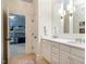 Bright bathroom features a double sink vanity with white cabinets and opens to a bedroom with playful wallpaper at 1616 Kirkby Ln, Raleigh, NC 27614
