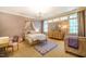 Charming bedroom with a whimsical canopy bed, matching dresser, and a cozy seating area at 1616 Kirkby Ln, Raleigh, NC 27614
