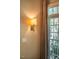 Window with elegant tassel draperies and wall-mounted sconce create a warm and inviting atmosphere at 1616 Kirkby Ln, Raleigh, NC 27614