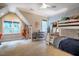 Spacious bedroom featuring a window seat, bunk beds, and modern blue and white patterned wallpaper at 1616 Kirkby Ln, Raleigh, NC 27614