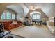 Spacious bonus room with a sofa, exercise equipment, and a pool table under vaulted ceilings at 1616 Kirkby Ln, Raleigh, NC 27614