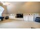 Large bonus room with built-in white cabinets and shelving on each side of the TV at 1616 Kirkby Ln, Raleigh, NC 27614