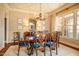Elegant dining room features decorative ceiling, beautiful chandelier, and windows overlooking the yard at 1616 Kirkby Ln, Raleigh, NC 27614