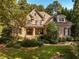 Charming stone and brick home with a well-manicured front yard and mature trees at 1616 Kirkby Ln, Raleigh, NC 27614