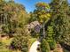 Inviting home nestled among mature trees, featuring a well-maintained lawn and landscaping at 1616 Kirkby Ln, Raleigh, NC 27614